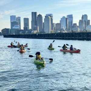 Kakayers in the Piers Park cove with the Boston skyline in the background.